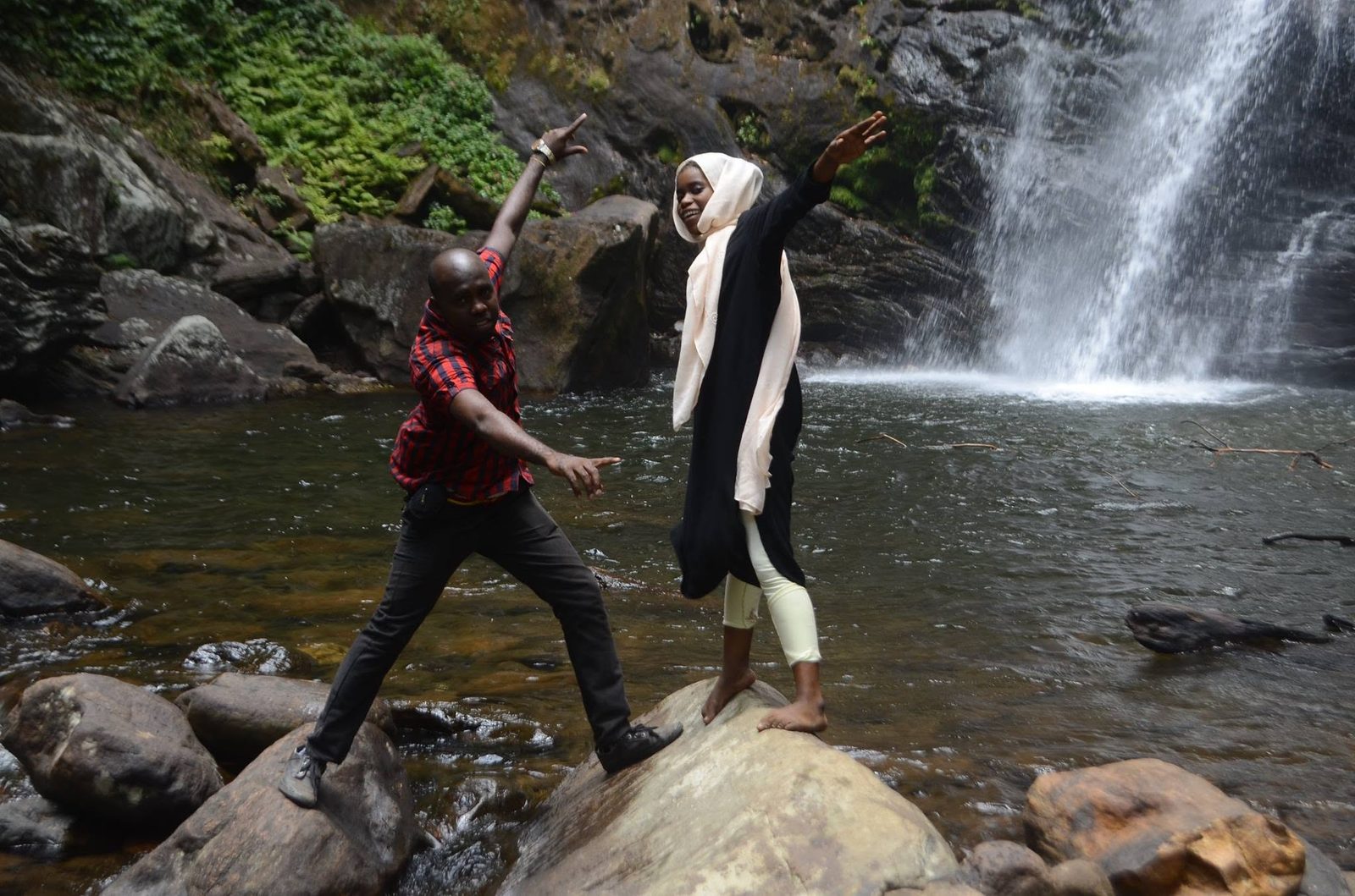 Guests hiking at Udzungwa waterfall near Mikumi